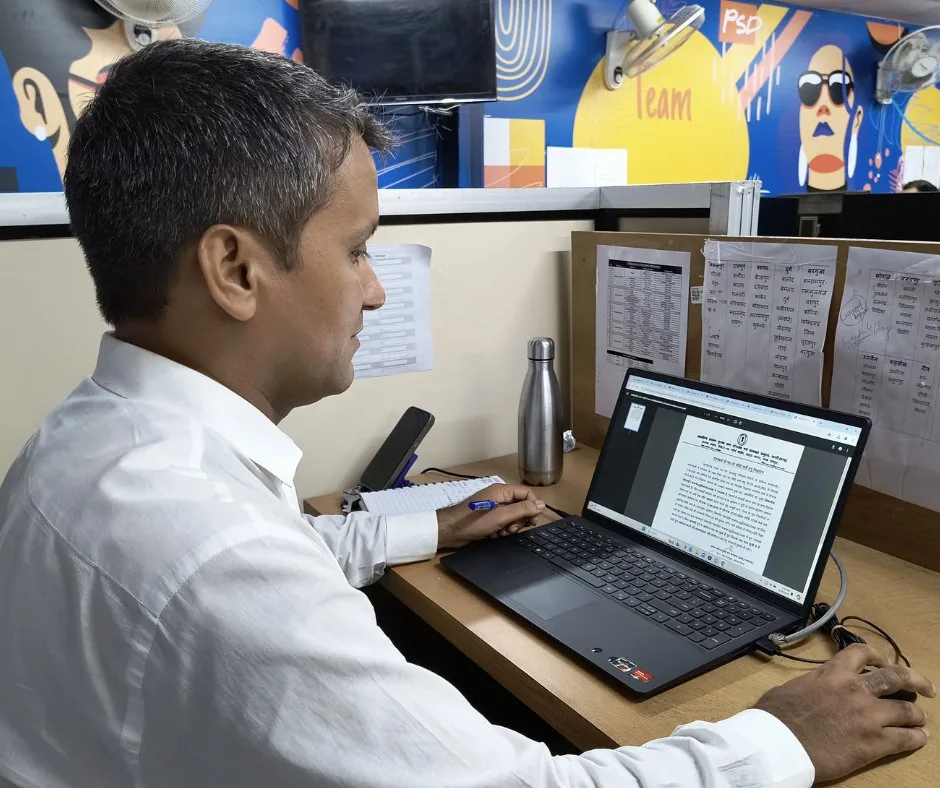Rahul Sharma working on an investigation at his newsroom desk